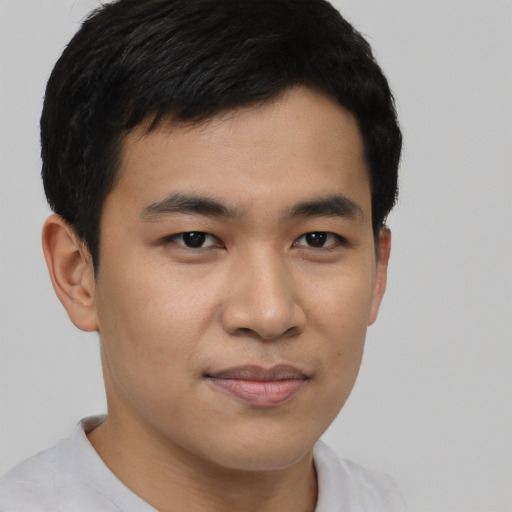Joyful asian young-adult male with short  black hair and brown eyes