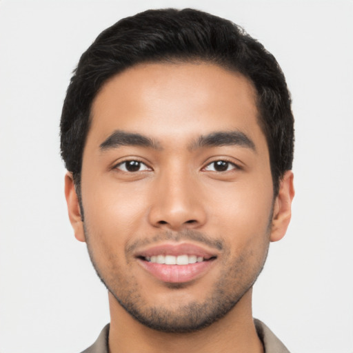 Joyful latino young-adult male with short  black hair and brown eyes