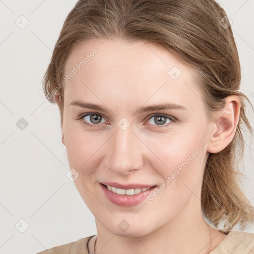 Joyful white young-adult female with medium  brown hair and grey eyes