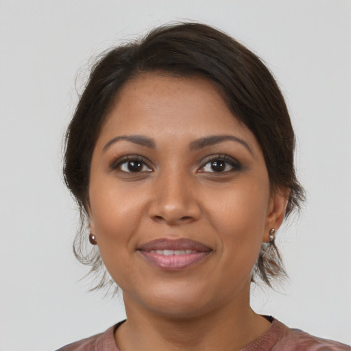 Joyful black young-adult female with medium  brown hair and brown eyes