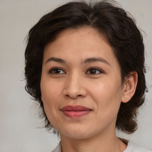 Joyful white adult female with medium  brown hair and brown eyes