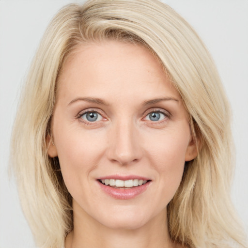 Joyful white young-adult female with long  brown hair and blue eyes