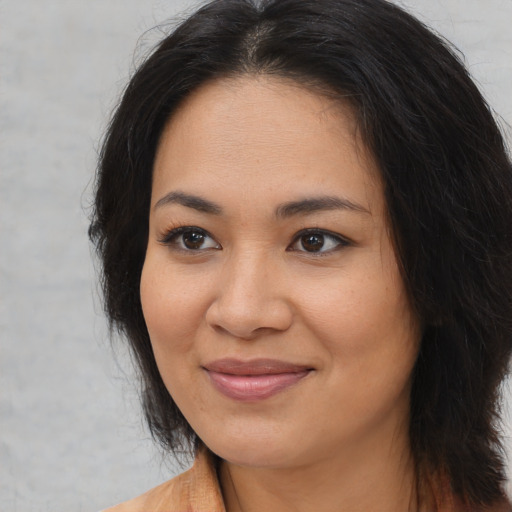 Joyful asian young-adult female with medium  brown hair and brown eyes