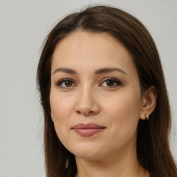 Joyful white young-adult female with long  brown hair and brown eyes