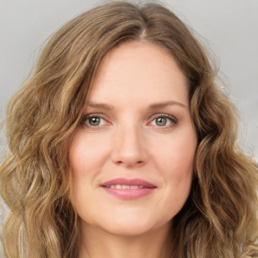 Joyful white young-adult female with long  brown hair and green eyes