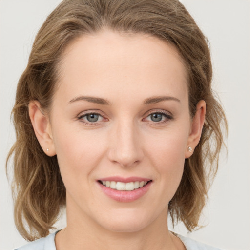 Joyful white young-adult female with medium  brown hair and blue eyes