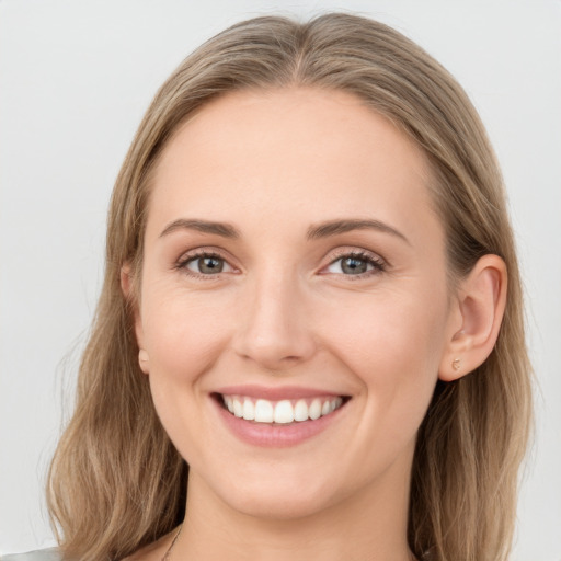 Joyful white young-adult female with long  brown hair and grey eyes