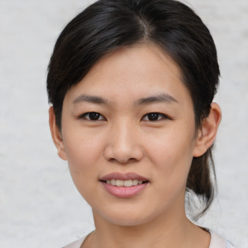 Joyful asian young-adult female with medium  brown hair and brown eyes