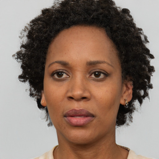Joyful black adult female with short  black hair and brown eyes
