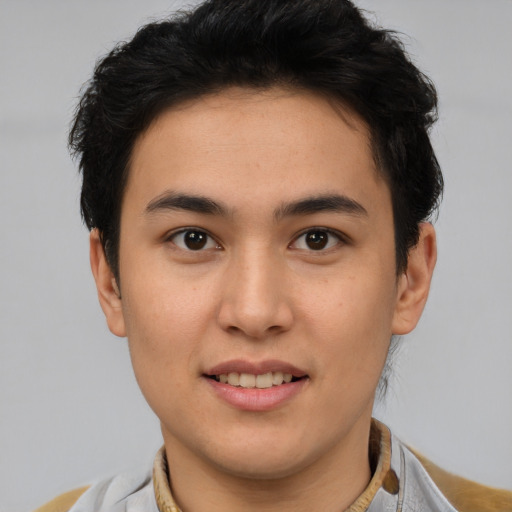 Joyful latino young-adult male with short  brown hair and brown eyes