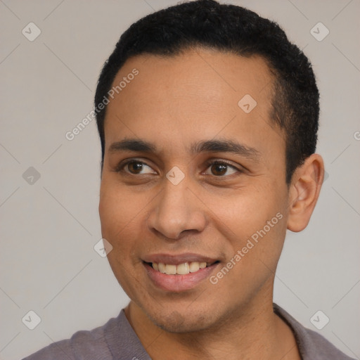 Joyful latino young-adult male with short  black hair and brown eyes