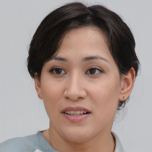 Joyful asian young-adult female with medium  brown hair and brown eyes