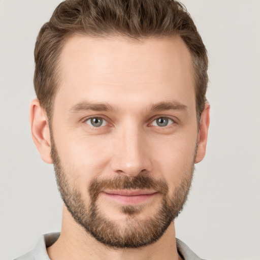 Joyful white young-adult male with short  brown hair and brown eyes