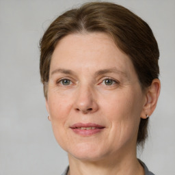 Joyful white adult female with medium  brown hair and grey eyes