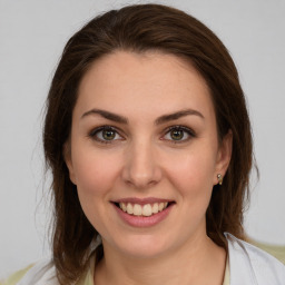 Joyful white young-adult female with medium  brown hair and green eyes