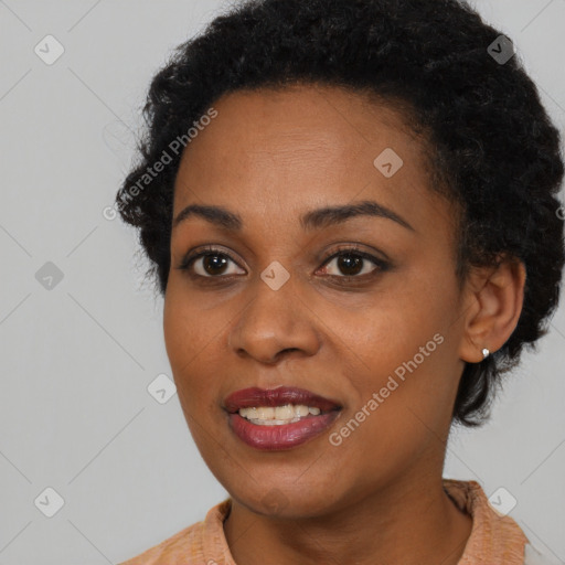 Joyful black young-adult female with short  brown hair and brown eyes