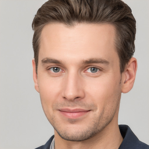 Joyful white young-adult male with short  brown hair and brown eyes