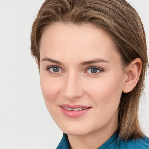 Joyful white young-adult female with long  brown hair and blue eyes