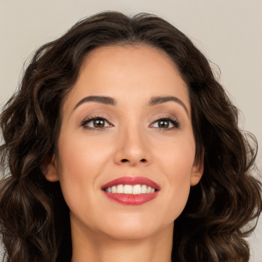 Joyful white young-adult female with long  brown hair and brown eyes