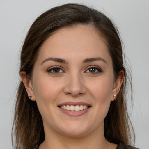 Joyful white young-adult female with long  brown hair and grey eyes