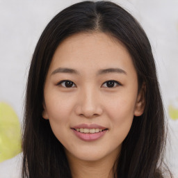 Joyful asian young-adult female with long  brown hair and brown eyes
