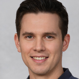 Joyful white young-adult male with short  brown hair and brown eyes