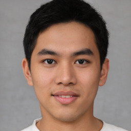 Joyful asian young-adult male with short  black hair and brown eyes