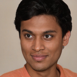 Joyful latino young-adult male with short  brown hair and brown eyes