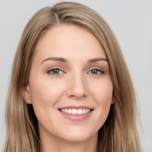 Joyful white young-adult female with long  brown hair and grey eyes