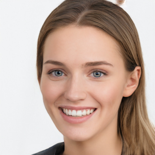 Joyful white young-adult female with long  brown hair and grey eyes