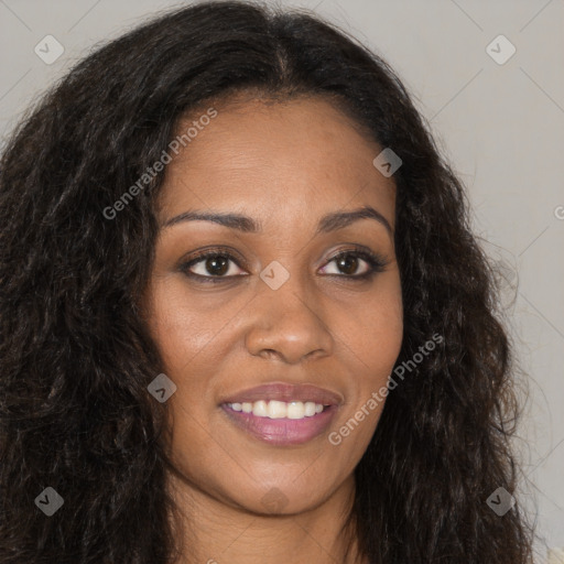 Joyful black young-adult female with long  brown hair and brown eyes