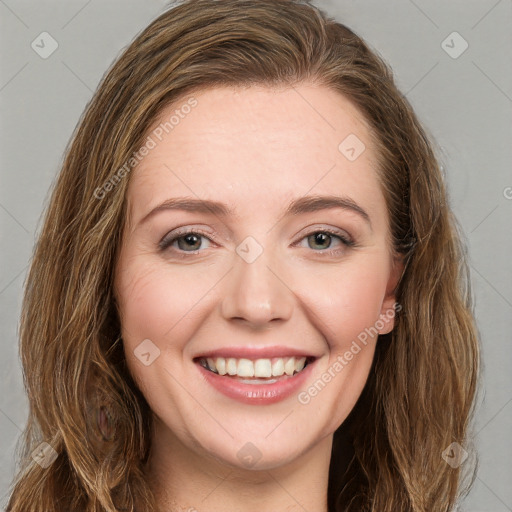 Joyful white young-adult female with long  brown hair and green eyes