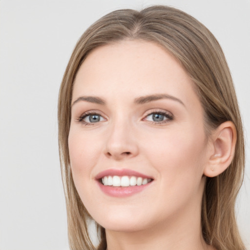 Joyful white young-adult female with long  brown hair and grey eyes