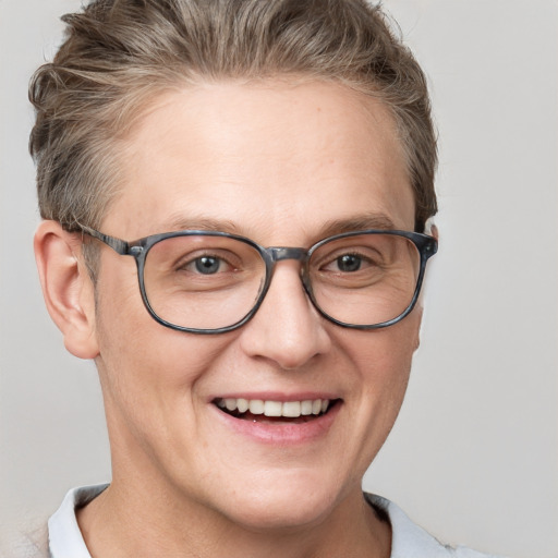 Joyful white adult male with short  brown hair and blue eyes