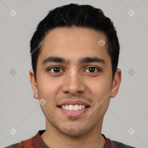 Joyful latino young-adult male with short  black hair and brown eyes