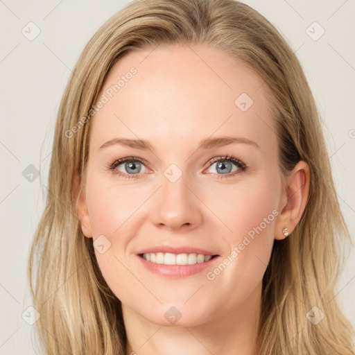 Joyful white young-adult female with long  brown hair and blue eyes