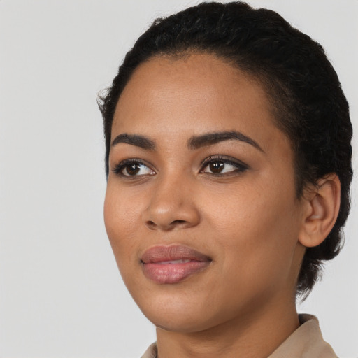 Joyful latino young-adult female with short  black hair and brown eyes