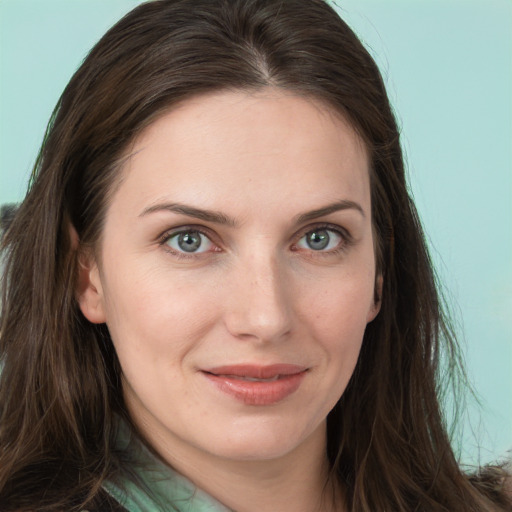 Joyful white young-adult female with long  brown hair and green eyes