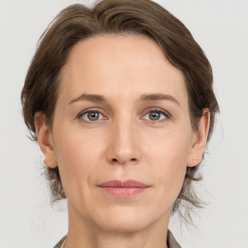 Joyful white adult female with medium  brown hair and grey eyes