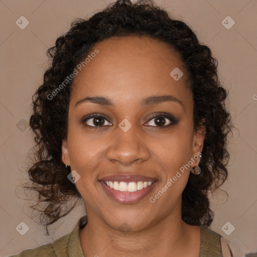 Joyful black young-adult female with long  brown hair and brown eyes