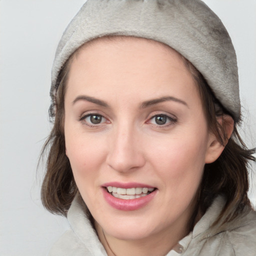 Joyful white young-adult female with medium  brown hair and blue eyes