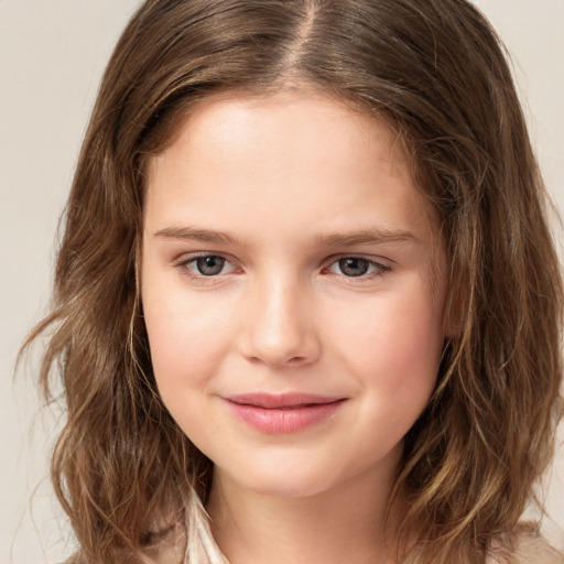 Joyful white child female with long  brown hair and brown eyes