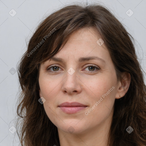 Joyful white adult female with long  brown hair and grey eyes