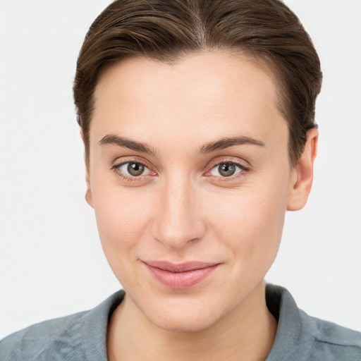 Joyful white young-adult female with short  brown hair and grey eyes