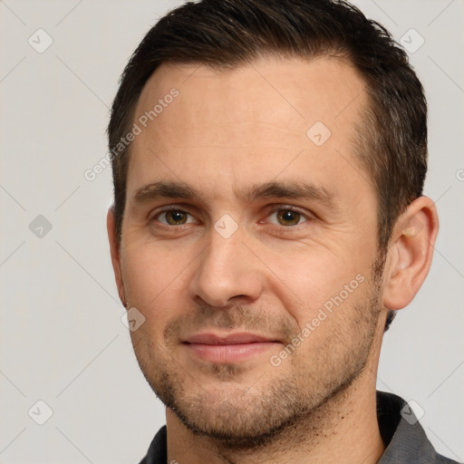 Joyful white adult male with short  brown hair and brown eyes