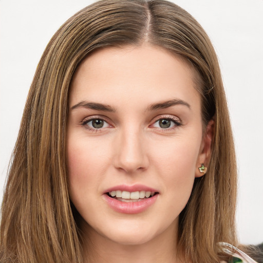 Joyful white young-adult female with long  brown hair and green eyes