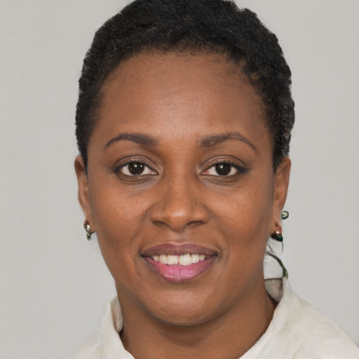 Joyful black adult female with short  brown hair and brown eyes