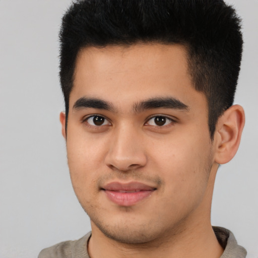 Joyful asian young-adult male with short  brown hair and brown eyes