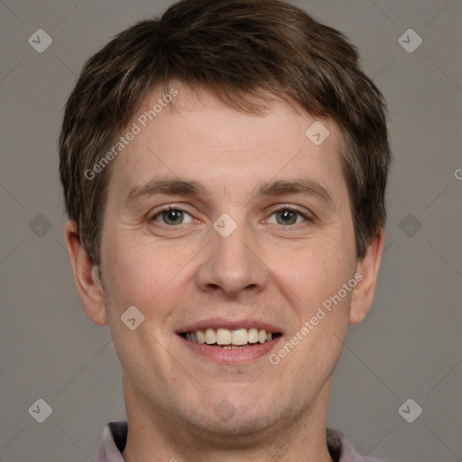 Joyful white adult male with short  brown hair and grey eyes