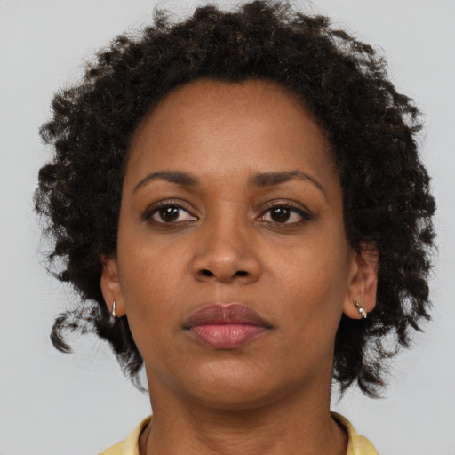 Neutral black adult female with short  brown hair and brown eyes